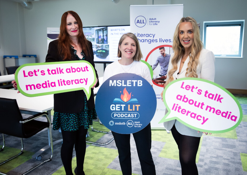 Group of three women holding photo props promoting Literacy and the Get Lit podcast