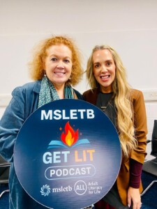 Two ladies smiling at camera and holding sign that says "MSLETB Get Lit Podcast."