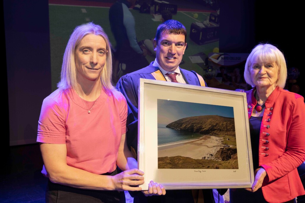 Cora Staunton receiving her honorary graduate award from Mayo College of Further Education and Training, presented by Michael Murphy, Principal of Mayo College of FET, alongside Minister of State Marian Harkin from the Department of Further and Higher Education, Research, Innovation and Science.