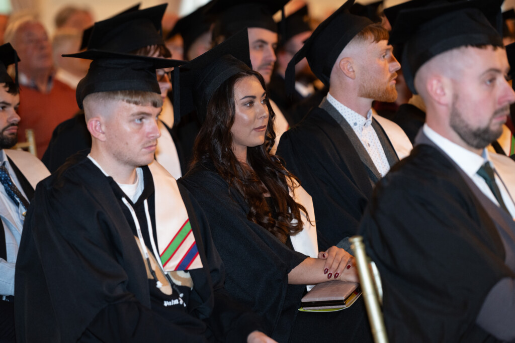 Male and Female graduates listening during the ceremony